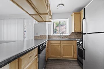 Boulder apartment for rent - a kitchen with wooden cabinets and stainless steel appliances and a window