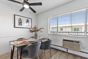 Littleton apartment for rent - a dining room with a table and chairs and a ceiling fan