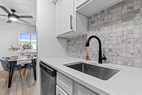 Littleton apartment for rent - the kitchen and dining area of a house with a sink