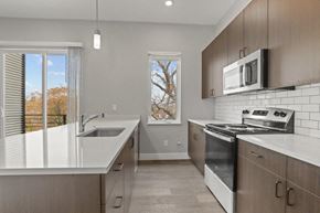 Denver apartment for rent - a kitchen with a sink and a stove and a window