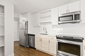 Boulder apartment for rent - a white kitchen with stainless steel appliances and white cabinets