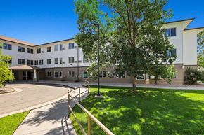 Greeley apartment for rent - a large white building with trees and a yard in front of it