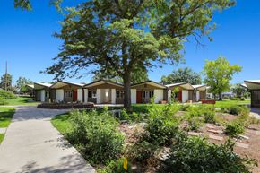 Greeley apartment for rent - a row of houses in a neighborhood with trees and a sidewalk