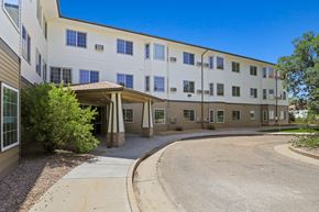 Greeley apartment for rent - a large white building with a round driveway and an entrance