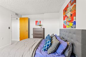 Greeley apartment for rent - a bedroom with a bed with pillows and a dresser