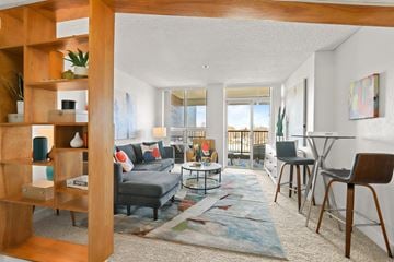 Greeley apartment for rent - a living room with a couch and a dining room and a balcony