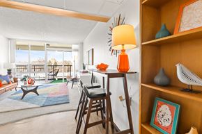 Greeley apartment for rent - a living room with a bar and a view of the living room and a balcony
