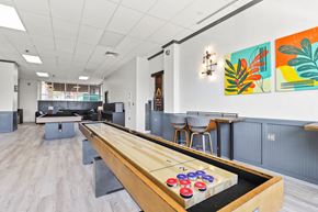 Greeley apartment for rent - a game room with a shuffleboard table in the middle