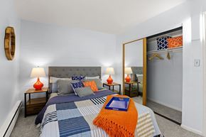 Greeley apartment for rent - a bedroom with a large bed and a mirror