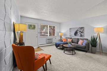Greeley apartment for rent - a living room with couches and chairs and a window