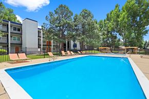 Fort Collins apartment for rent - A swimming pool in front of apartment buildings.