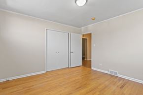 Denver apartment for rent - a living room with wood floors and a door to a hallway