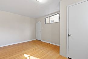 Denver apartment for rent - an empty bedroom with wood flooring and a white door