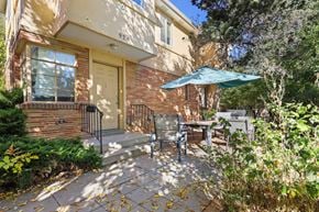 Boulder triplex for rent - the front of a house with a patio and an umbrella