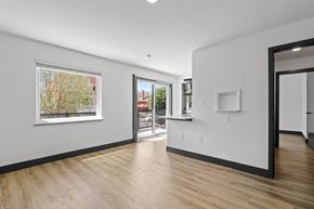 Denver apartment for rent - a bedroom with hardwood floors and white walls