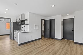 Denver apartment for rent - an open kitchen and living room with a hardwood floor