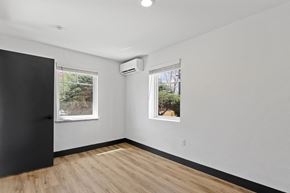 Denver apartment for rent - an empty room with two windows and a black door