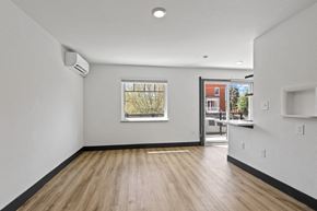 Denver apartment for rent - a living room with hardwood floors and white walls