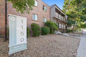 Denver apartment for rent - A sign for Stone Garden on Birch is in front of a building.