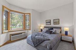 Greeley apartment for rent - a bedroom with a bed and a large window