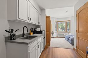 Greeley apartment for rent - a kitchen with a sink and a door to a bedroom