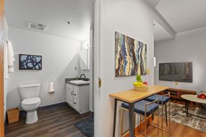 Greeley apartment for rent - a bathroom with a sink and a toilet and a dining room table