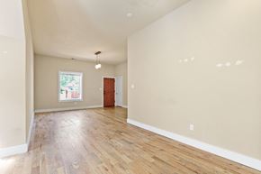 Denver apartment for rent - a living room with hardwood floors and beige walls