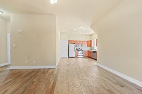 Denver apartment for rent - a living and kitchen area with hardwood floors and white walls