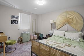 Boulder apartment for rent - A bedroom with a bed, chair, and lamp.