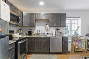 Boulder apartment for rent - A kitchen with dark wood cabinets and stainless steel appliances.