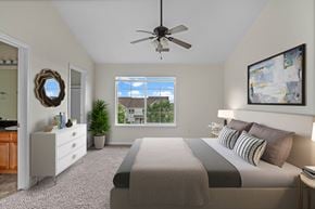 Thornton townhouse for rent - A bedroom with a large bed and a ceiling fan.