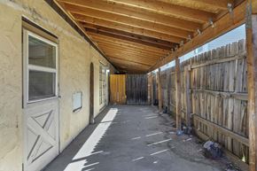 Lakewood apartment for rent - A long covered walkway with a wooden fence on the right side.