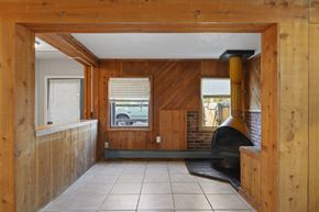 Lakewood apartment for rent - A room with wooden walls and a black oven.
