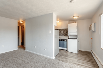 Greeley apartment for rent - A kitchen area with a dishwasher and a refrigerator.