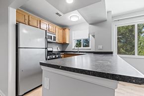 Boulder apartment for rent - A kitchen with a black countertop and a stainless steel refrigerator.