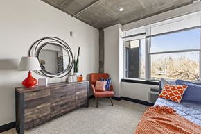Greeley apartment for rent - A bedroom with a large bed and a chair.