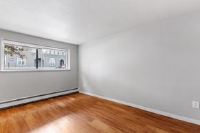 Denver apartment for rent - the living room of an apartment with wood floors and a window