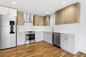 Denver apartment for rent - a renovated kitchen with white cabinets and stainless steel appliances