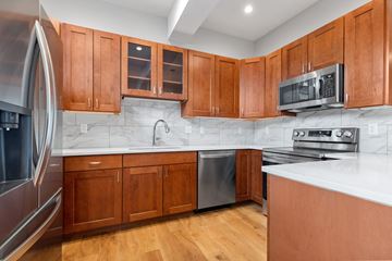 Boulder apartment for rent - A kitchen with wooden cabinets and a white counter.