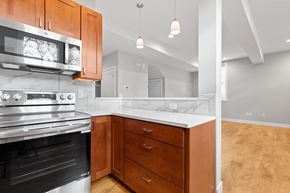 Boulder apartment for rent - A modern kitchen with wooden cabinets and a stainless steel oven.