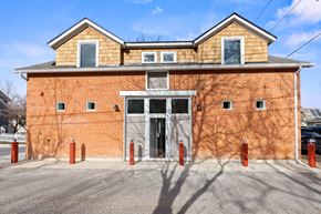 Boulder apartment for rent - A red brick building with a grey roof and a white door.