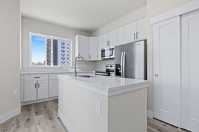 Denver apartment for rent - A kitchen with white cabinets and a stainless steel refrigerator.