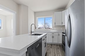 Denver apartment for rent - A modern kitchen with a large island and stainless steel appliances.