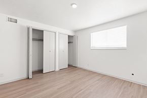 Lakewood apartment for rent - the living room of an apartment with white walls and wood flooring