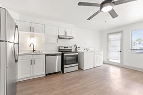 Lakewood apartment for rent - an empty kitchen with white appliances and a ceiling fan