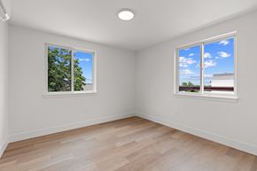 Boulder apartment for rent - a living room with two windows and a wooden floor