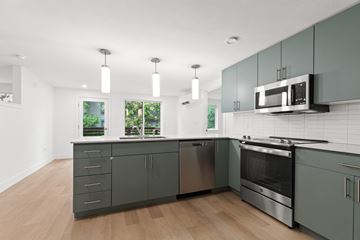 Boulder apartment for rent - a modern kitchen with gray cabinets and stainless steel appliances