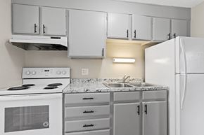 Denver apartment for rent - an empty kitchen with white appliances and white cabinets