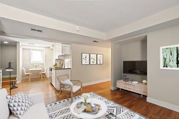 Boulder triplex for rent - A living room with a white couch and a coffee table in the center.