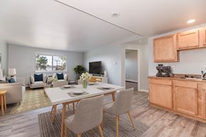 Denver apartment for rent - A modern dining room with a white table and chairs.
